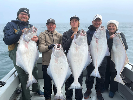 Family holding halibut.